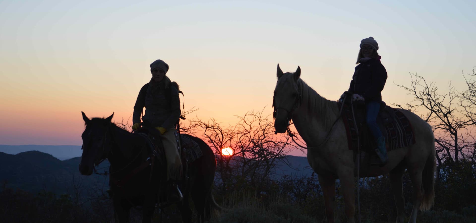 horseback riding in the sunset with rocky mountain outfitters