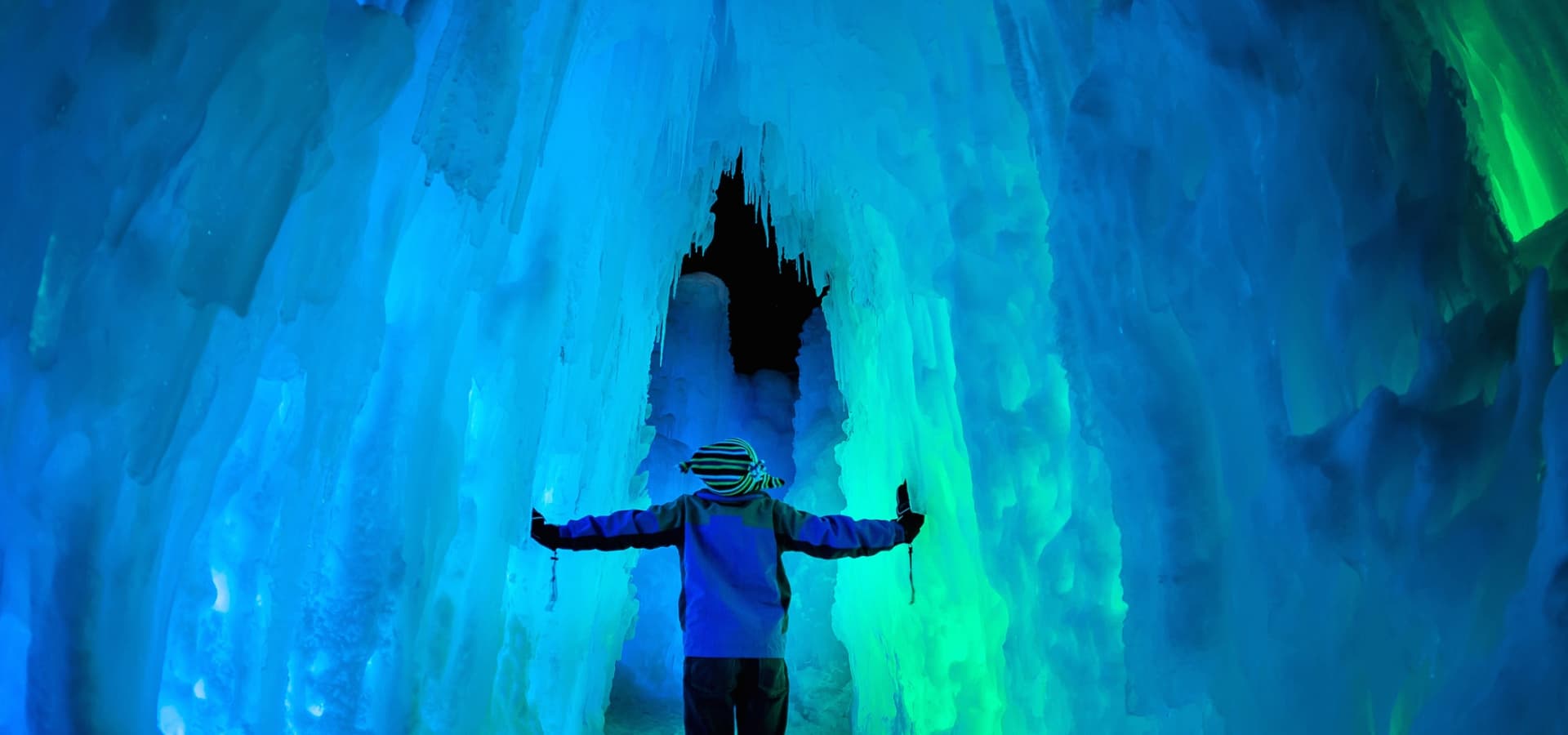 Little boy walking through ice castles